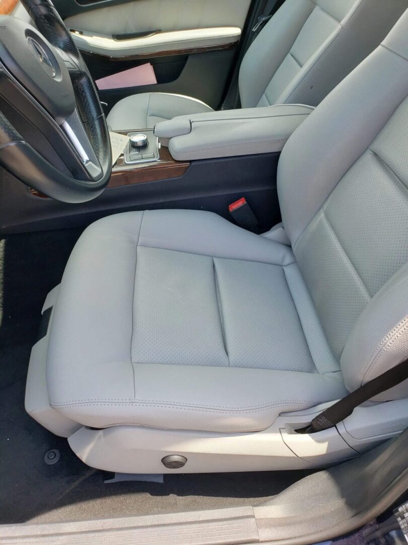 A picture of a grey color car seat with professional finishing